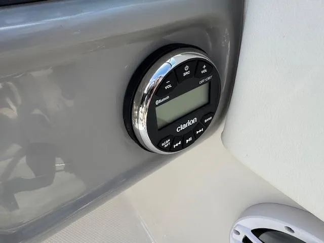 Slide: The Image of 2024 Robalo R207 Dual Console boat with Clarion audio system control panel. - 6