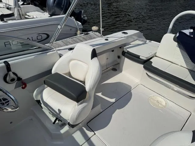 Slide: The Image of 2024 Robalo R207 Dual Console boat interior with white seating and water view. - 7