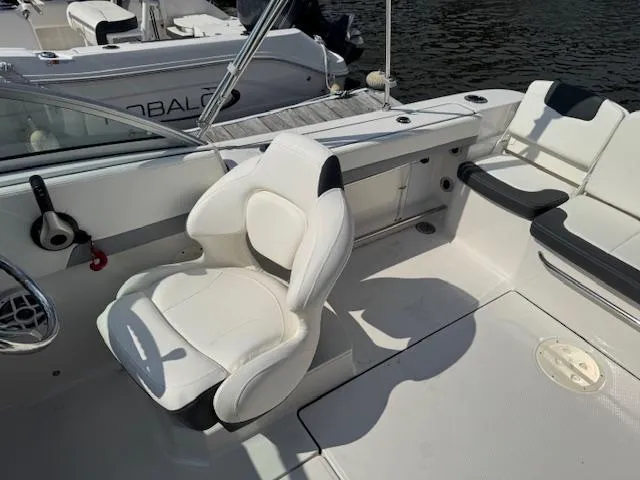 Slide: The Image of 2024 Robalo R207 Dual Console boat interior with white seating and steering wheel. - 8
