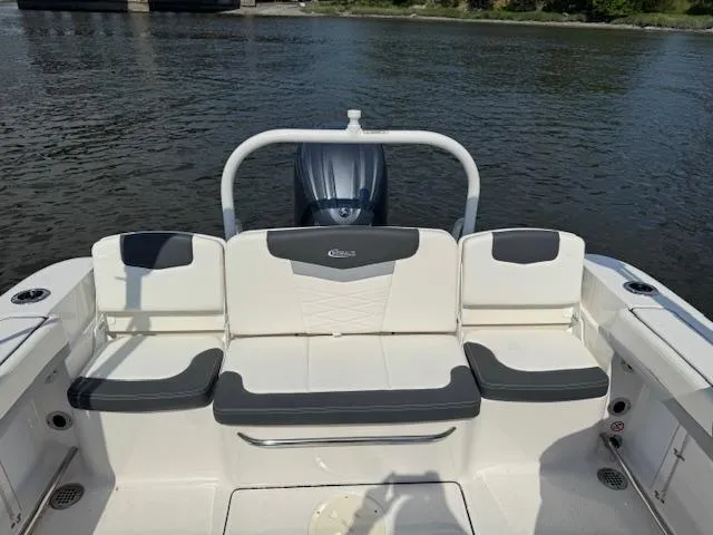 Slide: The Image of 2024 Robalo R207 Dual Console boat interior with seating, on calm water. - 9