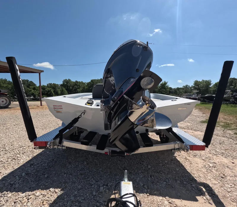 Slide: The Image of 2026 Xpress H 18 BASS boat on trailer, rear view, sunny day. - 10