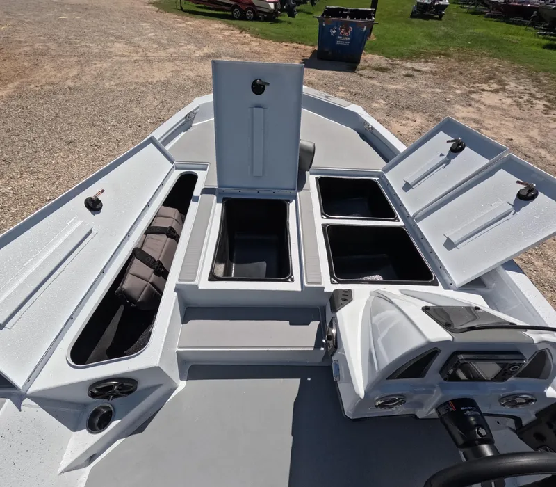 Slide: The Image of 2026 Xpress H 18 BASS boat with open storage compartments and steering console. - 4