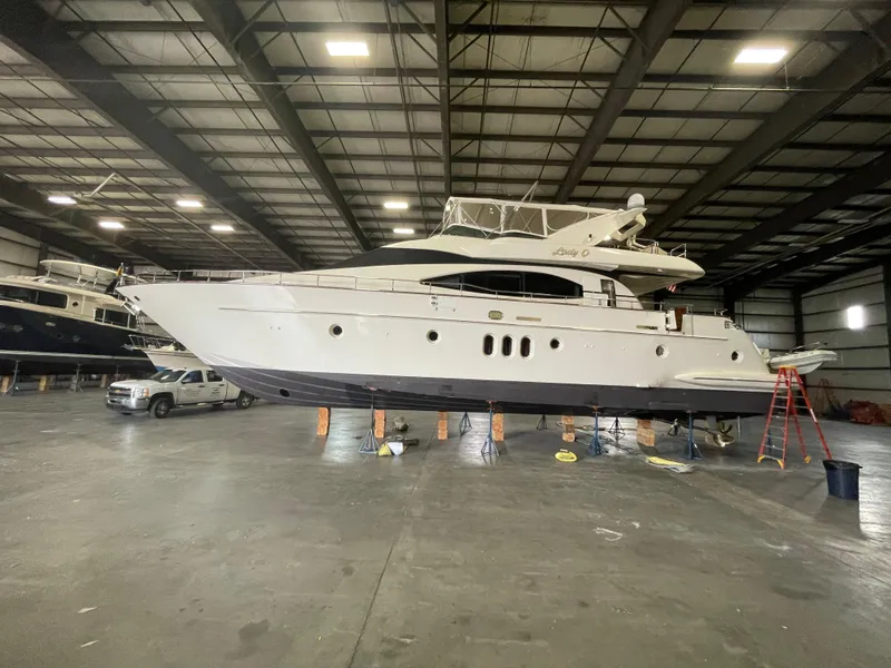 Slide: The Image of 2004 Azimut 74 yacht in indoor storage facility, elevated on supports. - 10
