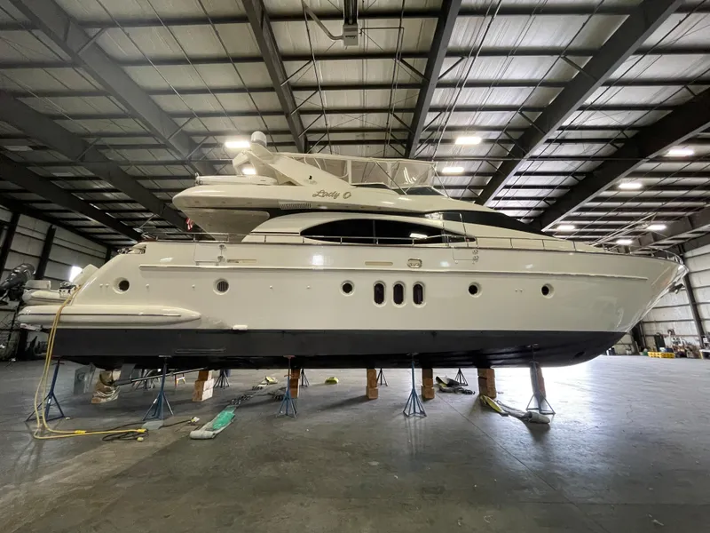 Slide: The Image of 2004 Azimut 74 yacht in a warehouse, elevated on stands. - 12