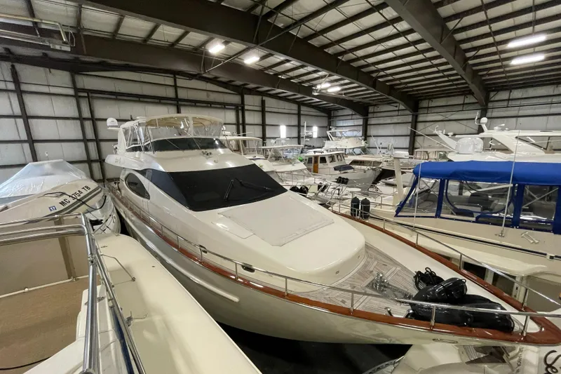 Slide: The Image of 2004 Azimut 74 yacht in indoor storage, surrounded by other boats. - 15