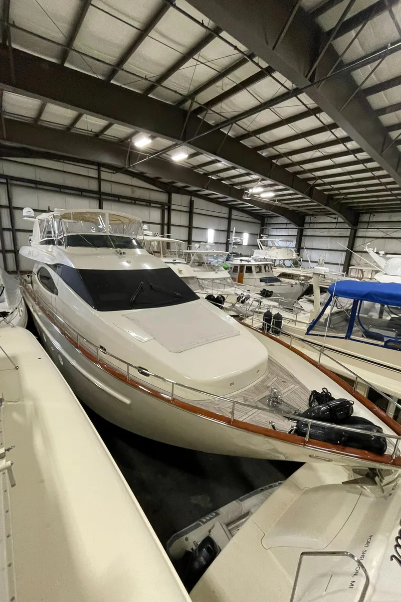 Slide: The Image of 2004 Azimut 74 yacht in a spacious indoor marina storage facility. - 16
