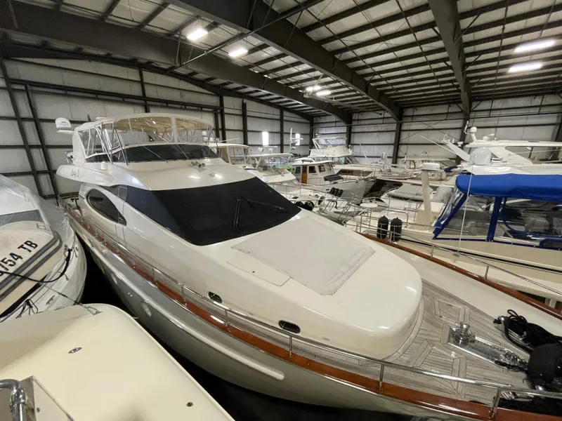 Slide: The Image of 2004 Azimut 74 yacht in indoor storage, surrounded by other boats. - 17