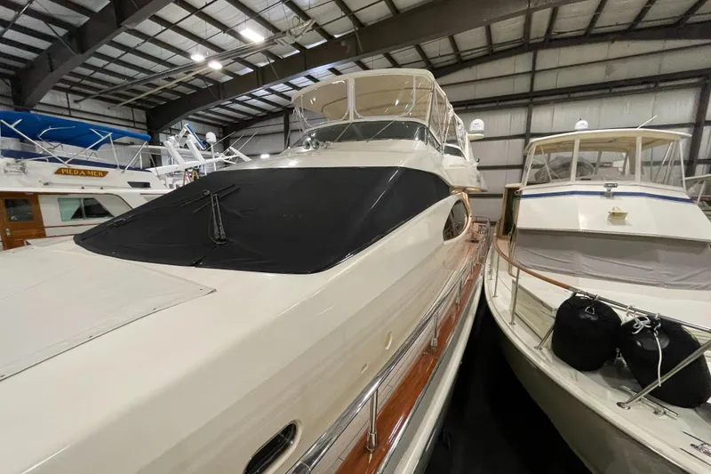 Slide: The Image of 2004 Azimut 74 yacht in indoor storage, alongside other boats. - 23
