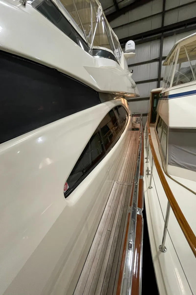 Slide: The Image of 2004 Azimut 74 yacht in storage, showcasing sleek design and polished exterior. - 27