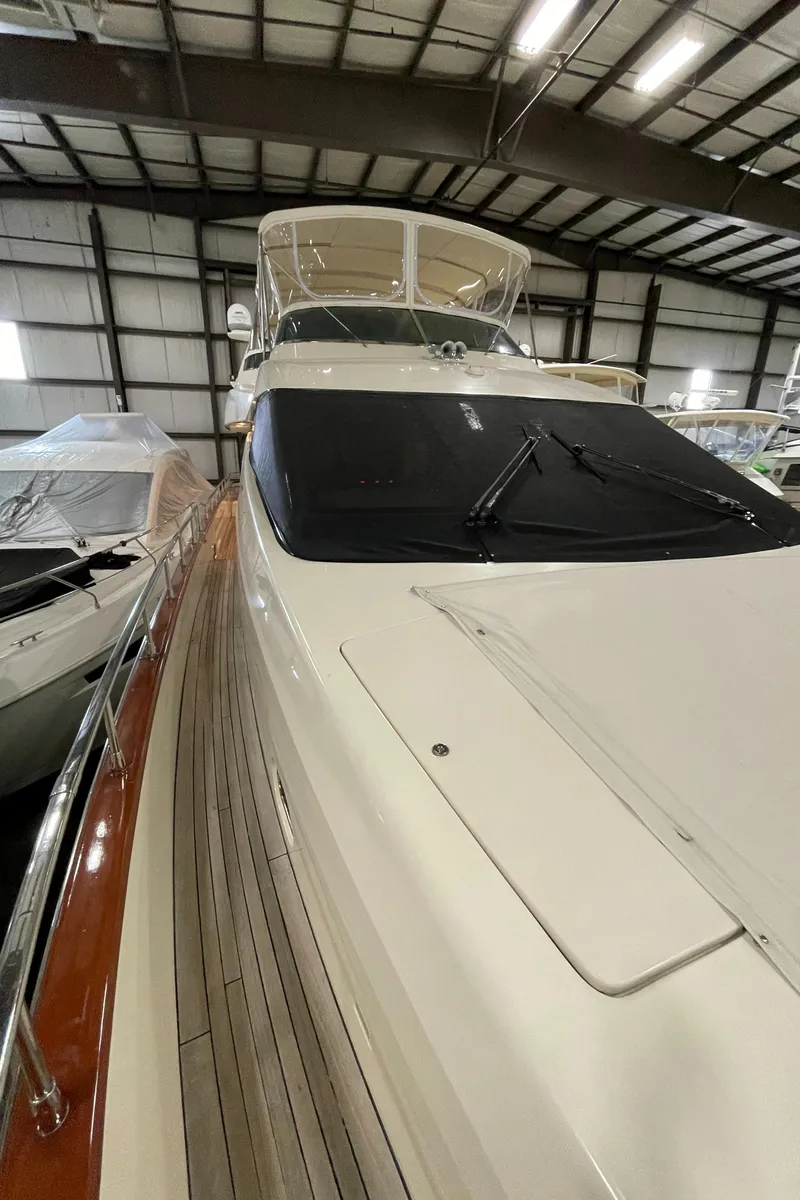 Slide: The Image of 2004 Azimut 74 yacht in indoor storage, showcasing sleek design and luxury features. - 29