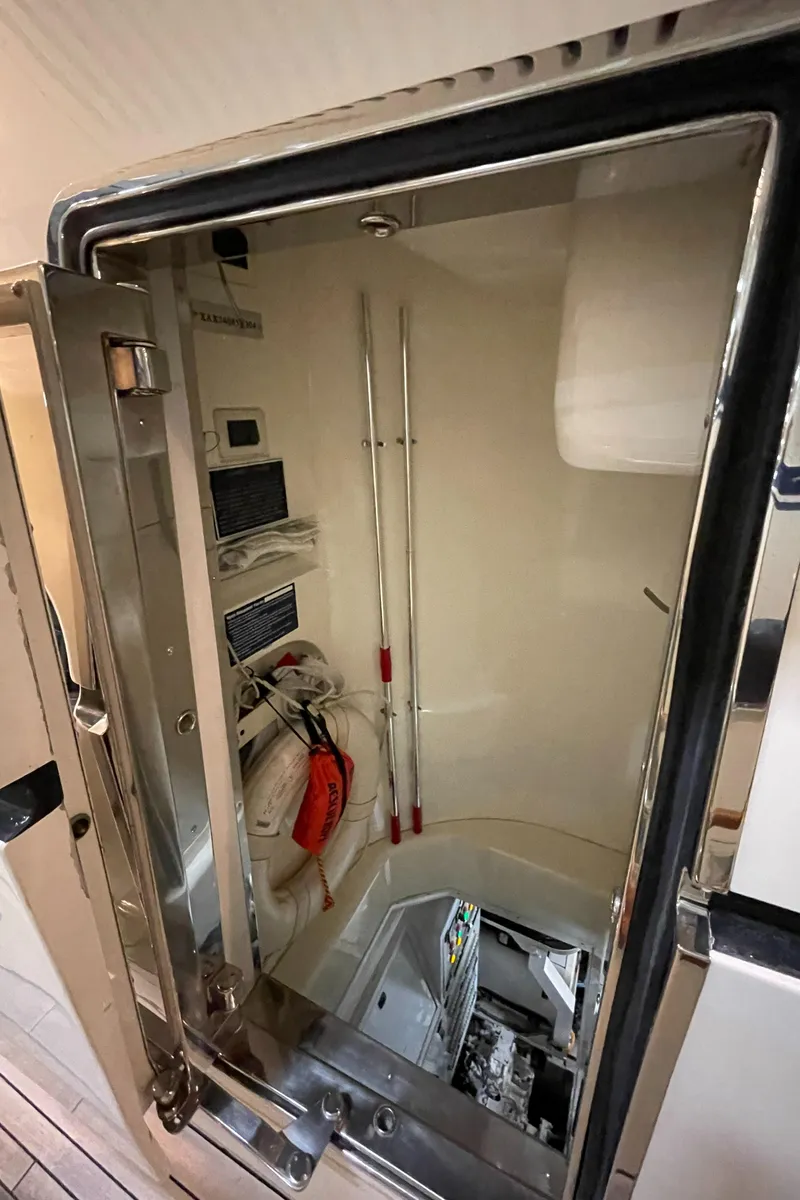 Slide: The Image of Engine room access on a 2004 Azimut 74 yacht, featuring safety equipment and controls. - 31