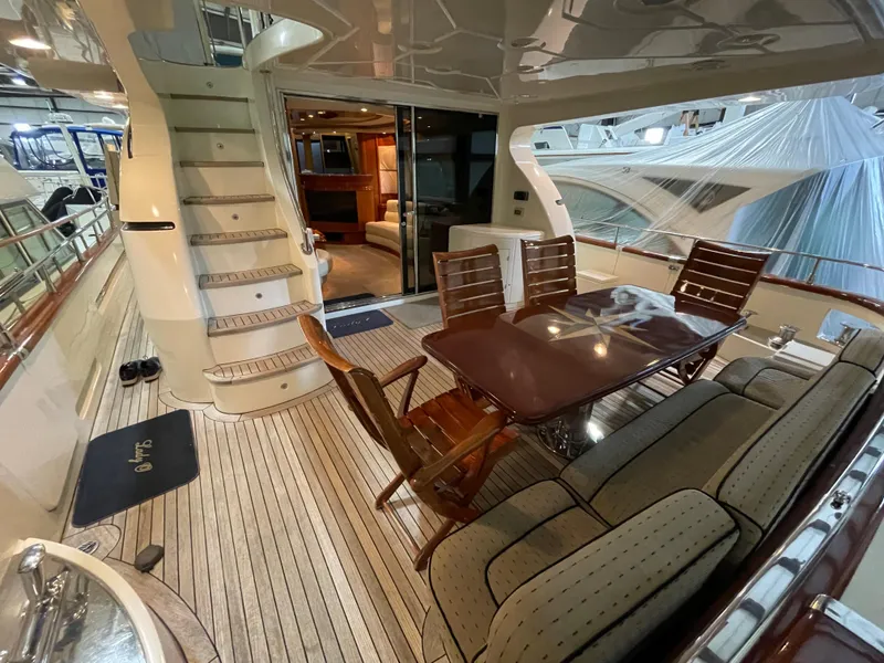 Slide: The Image of Luxurious 2004 Azimut 74 yacht deck with elegant dining area and staircase. - 36