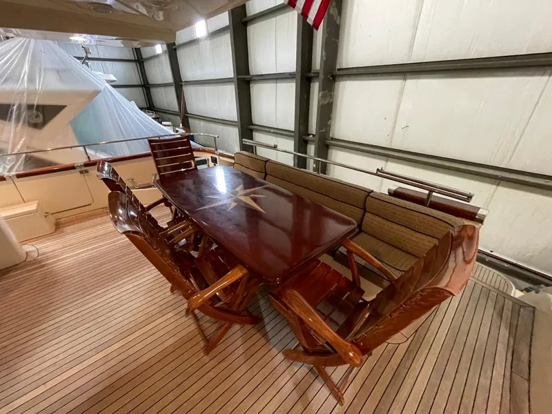 Slide: The Image of Luxurious 2004 Azimut 74 yacht deck with elegant wooden dining table and chairs. - 39