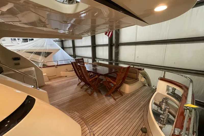 Slide: The Image of Luxurious 2004 Azimut 74 yacht deck with elegant wooden seating area. - 40