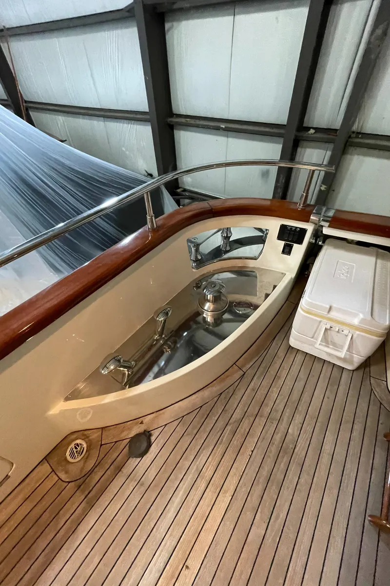 Slide: The Image of 2004 Azimut 74 yacht deck with wooden flooring and storage compartment. - 42