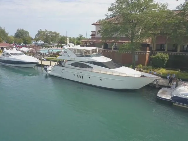 Slide: The Image of 2004 Azimut 74 yacht docked by a waterfront building. - 7