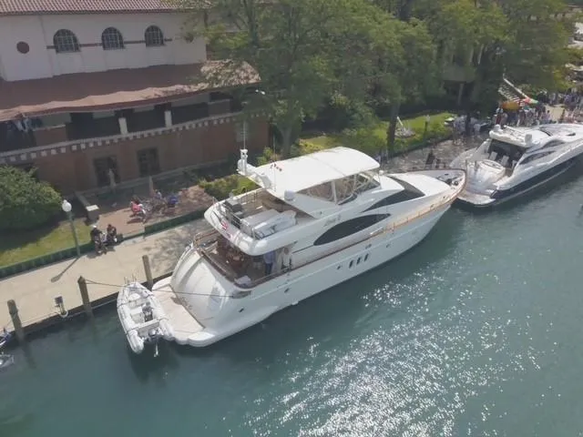 Slide: The Image of Aerial view of a 2004 Azimut 74 yacht docked near a waterfront building. - 8