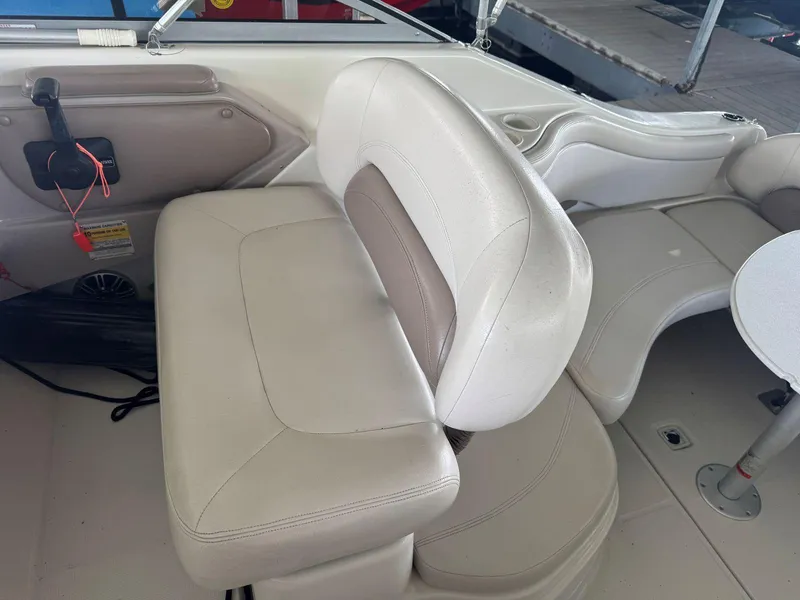 Slide: The Image of Interior of a 2000 Regal Commodore 2460 boat with white seating and control panel. - 11