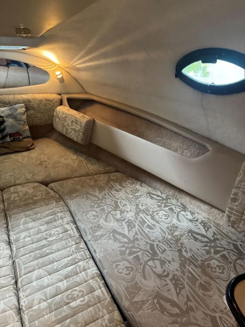 Slide: The Image of Interior cabin of 2000 Regal Commodore 2460 with patterned upholstery and porthole window. - 15