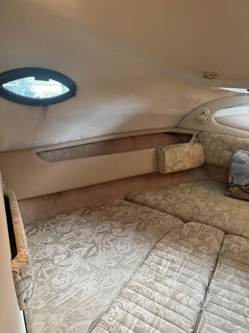 Slide: The Image of Interior cabin of 2000 Regal Commodore 2460 with floral upholstery and porthole window. - 16