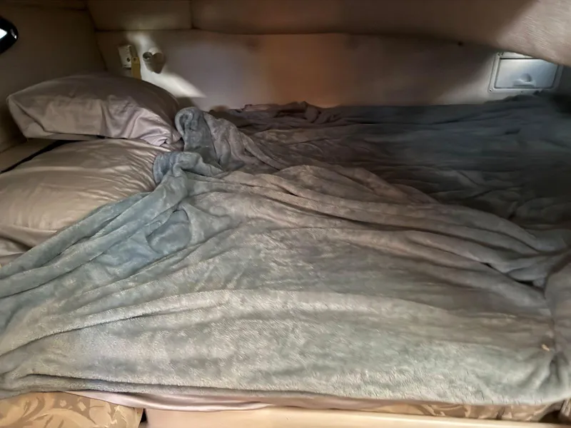 Slide: The Image of Cozy sleeping area inside a 2000 Regal Commodore 2460 boat cabin. - 19