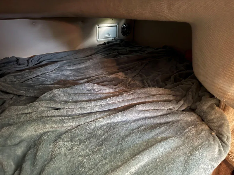 Slide: The Image of Cozy cabin interior of 2000 Regal Commodore 2460 with soft bedding. - 20