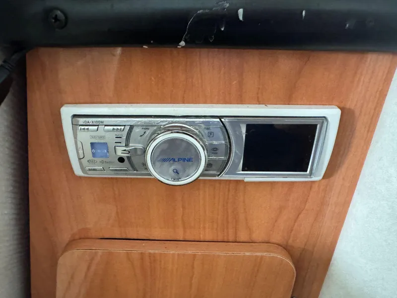 Slide: The Image of Alpine iDA-X100M stereo in 2000 Regal Commodore 2460 boat, mounted on wood panel. - 22