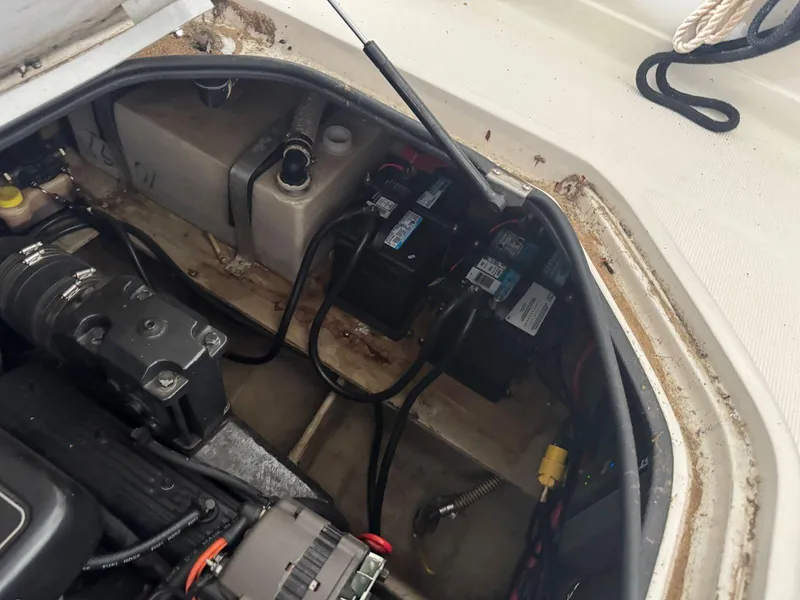 Slide: The Image of Engine compartment of a 2000 Regal Commodore 2460 boat, showing batteries and wiring. - 24