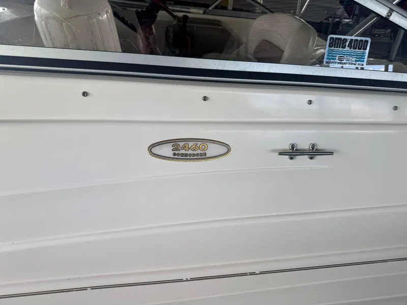 Slide: The Image of 2000 Regal Commodore 2460 boat side view with model emblem and interior glimpse. - 3