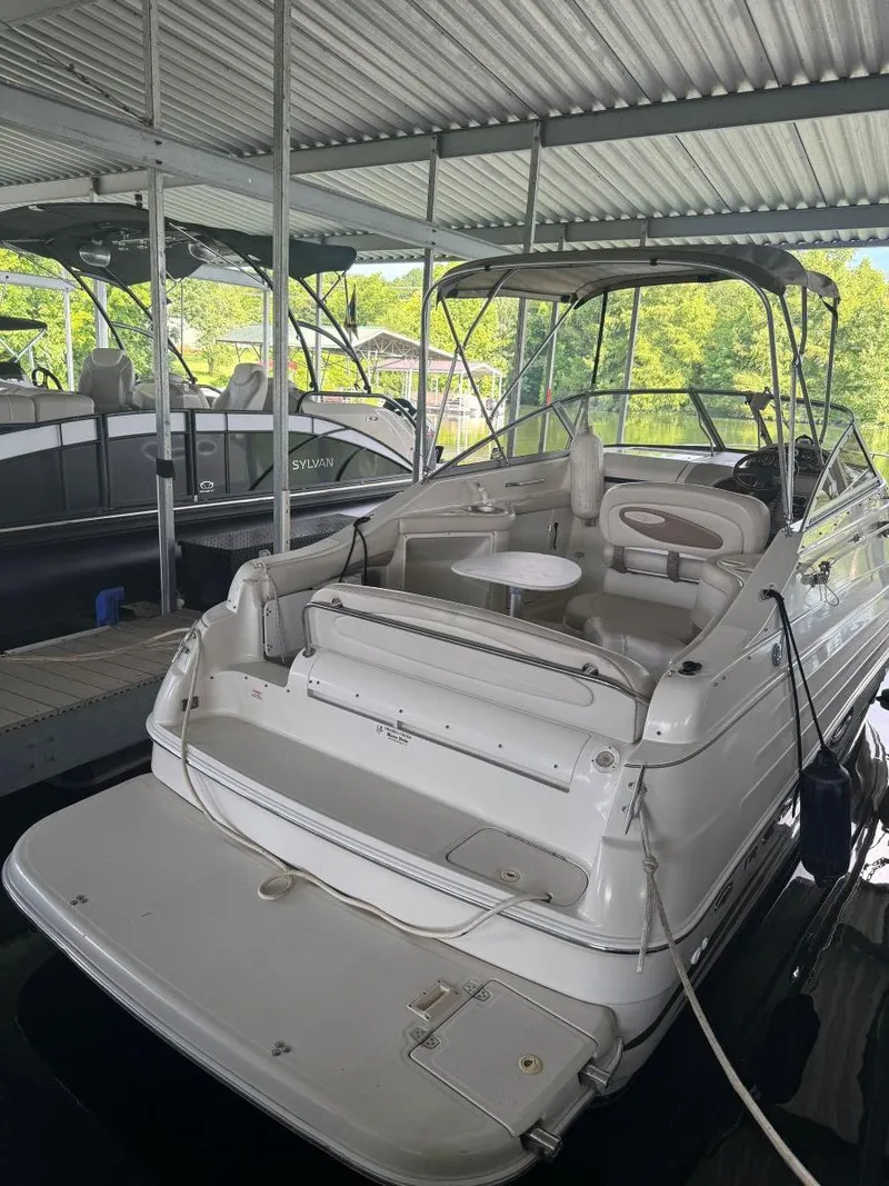 Slide: The Image of 2000 Regal Commodore 2460 boat docked under a covered marina. - 5