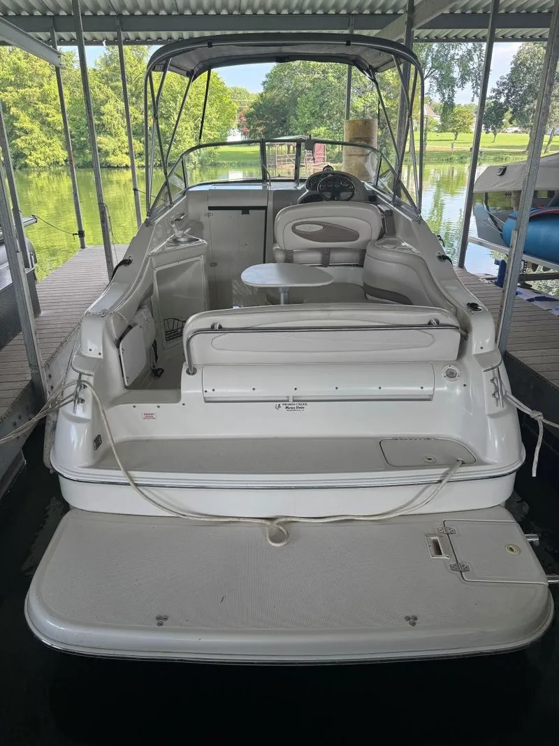 Slide: The Image of 2000 Regal Commodore 2460 boat docked, featuring spacious seating and a covered helm. - 8