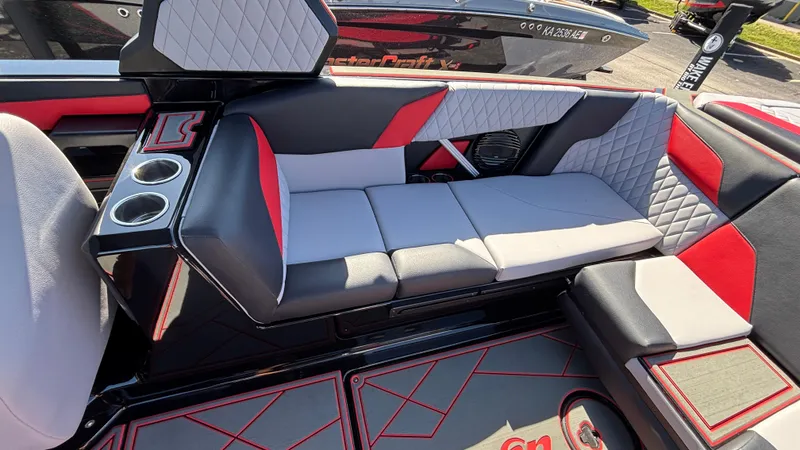 Slide: The Image of 2026 Tigé Z5 boat interior with red and gray seating, cup holders, and quilted design. - 10