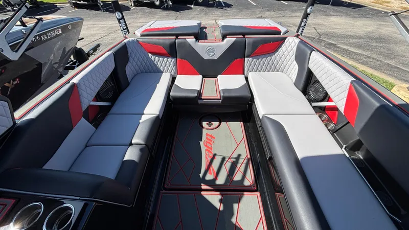 Slide: The Image of 2026 Tigé Z5 boat interior with red and gray seating, quilted accents, and cup holders. - 11