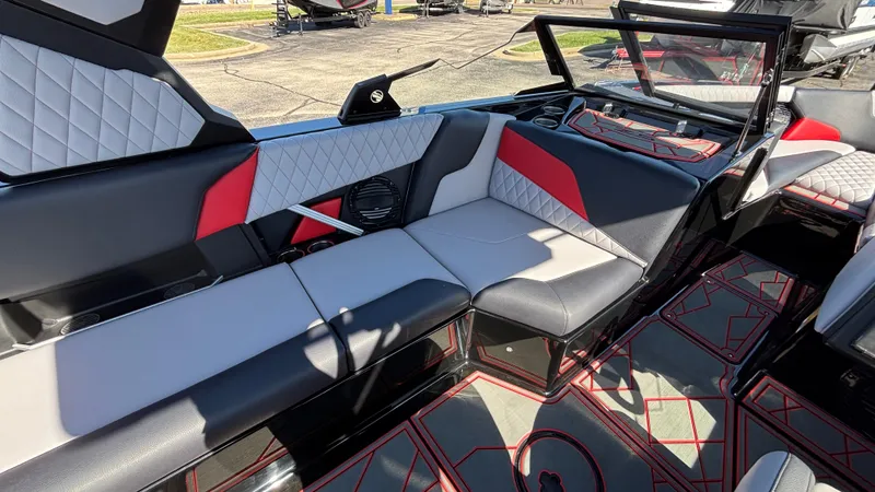 Slide: The Image of 2026 Tigé Z5 boat interior with modern seating, red and gray accents, and stylish design. - 13