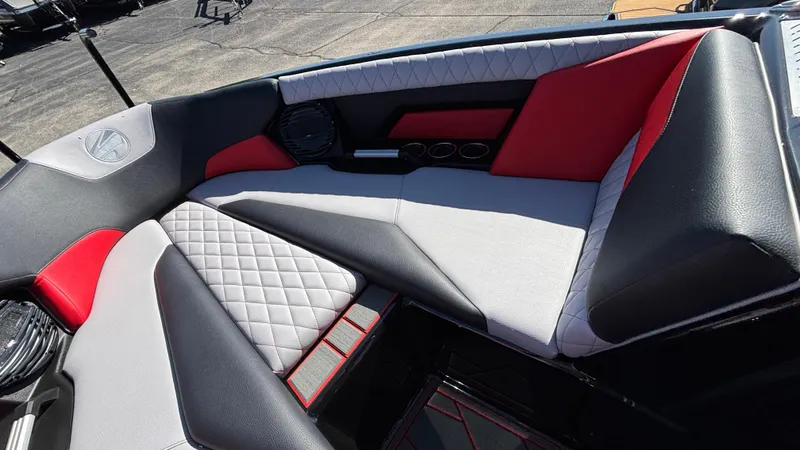 Slide: The Image of 2026 Tigé Z5 boat interior with red, black, and white cushioned seating. - 16