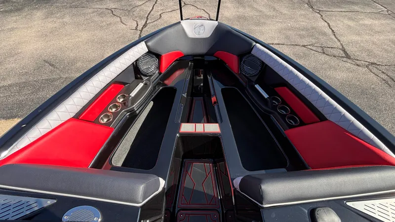 Slide: The Image of 2026 Tigé Z5 boat interior with red and black seating, cup holders, and speakers. - 19