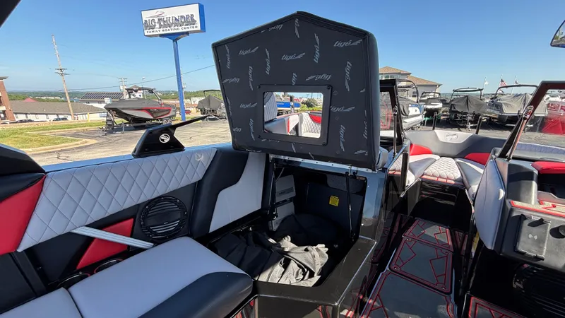Slide: The Image of 2026 Tigé Z5 boat interior with stylish seating and storage, displayed at a boating center. - 23