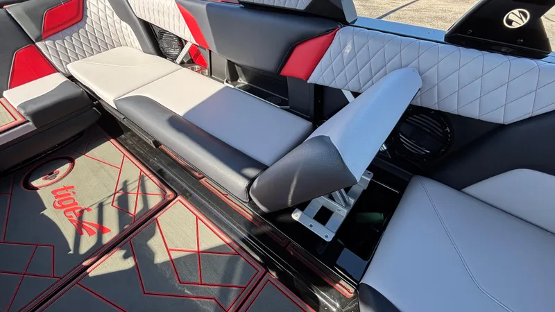 Slide: The Image of 2026 Tigé Z5 boat interior with red and gray seating, quilted design, and logo on floor. - 24