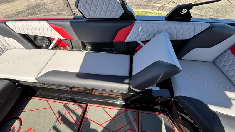 Slide: The Image of 2026 Tigé Z5 boat interior with modern, quilted upholstery and red accents. - 25