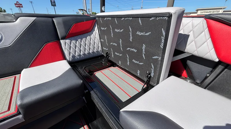 Slide: The Image of 2026 Tigé Z5 boat interior with red, black, and white seating and storage compartment. - 27