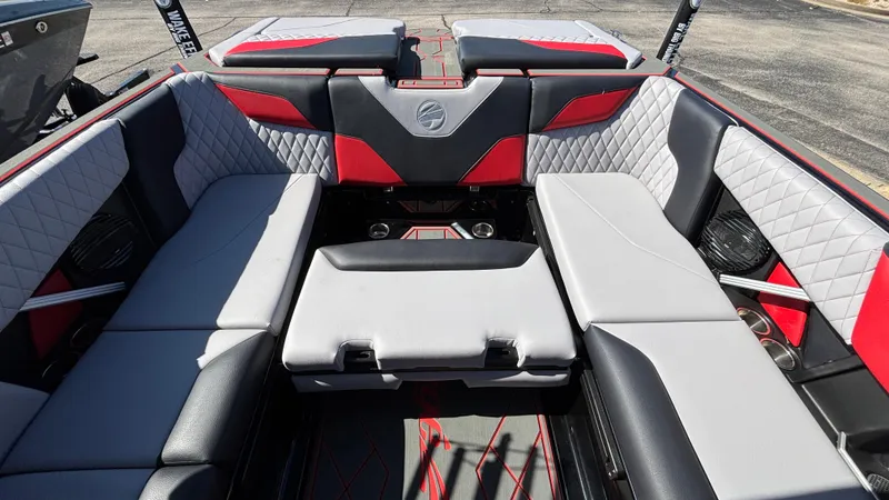 Slide: The Image of 2026 Tigé Z5 boat interior with red and gray seating, diamond stitching, and cup holders. - 30