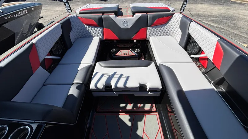 Slide: The Image of 2026 Tigé Z5 boat interior with red and gray seating, diamond stitching, and cup holders. - 31