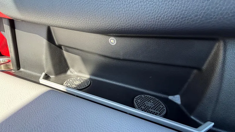 Slide: The Image of Interior detail of 2026 Tigé Z5 boat, featuring sleek black paneling and integrated speakers. - 48