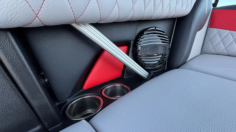 Slide: The Image of 2026 Tigé Z5 interior detail with speaker, cup holders, and red accents. - 49