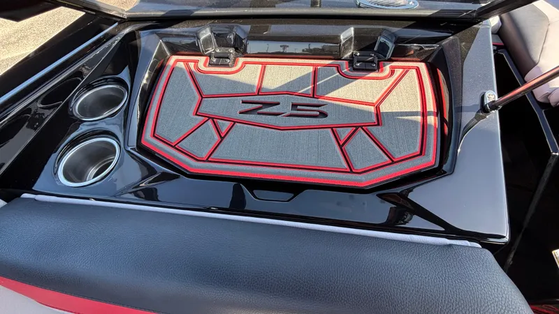 Slide: The Image of 2026 Tigé Z5 boat interior with cup holders and stylish red-trimmed storage compartment. - 8