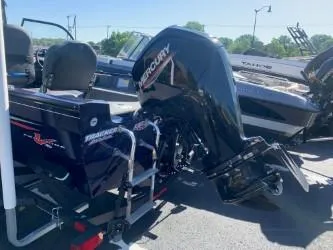 Slide: The Image of 2022 Tracker Pro Guide V-16 WT boat with Mercury outboard motor, parked outdoors. - 4