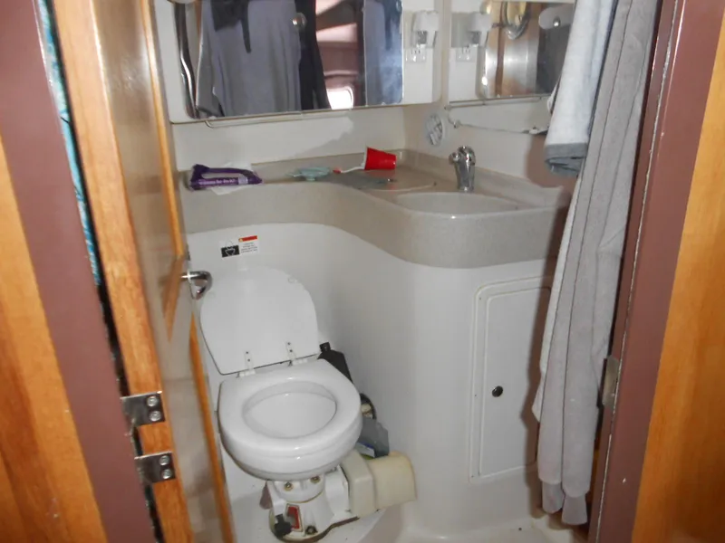 Slide: The Image of Compact bathroom in a 2004 Catalina 387 sailboat, featuring a toilet and sink. - 19