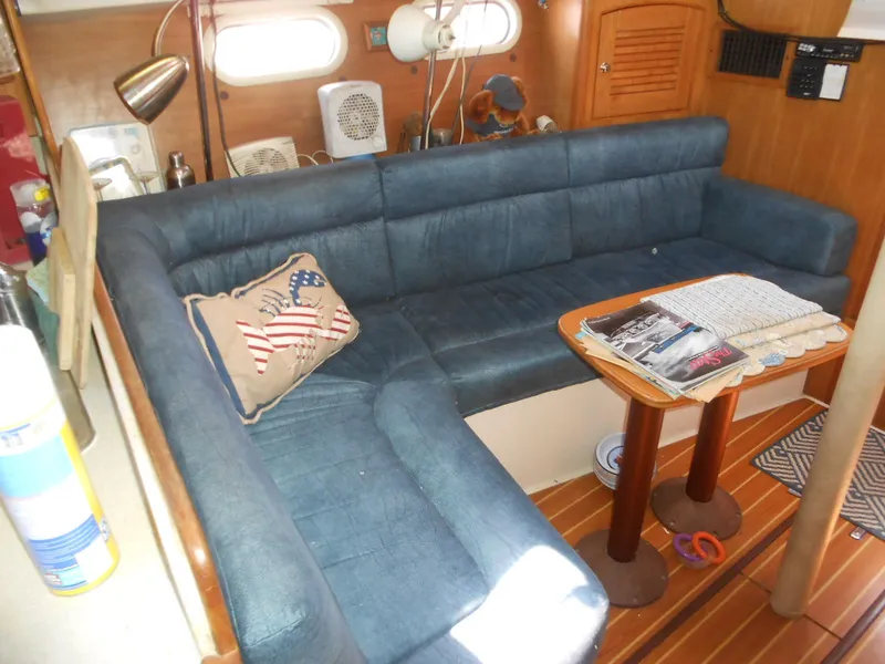 Slide: The Image of Interior of a 2004 Catalina 387 sailboat with blue seating and nautical decor. - 20