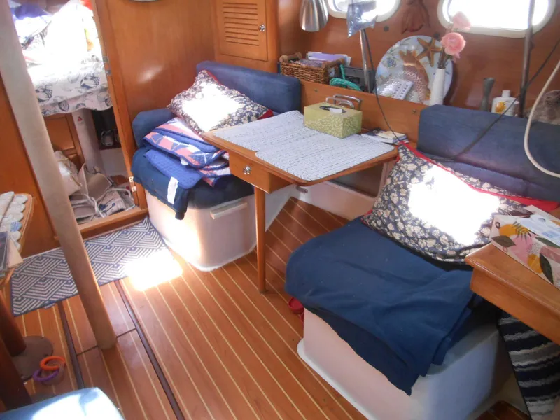 Slide: The Image of Cozy interior of 2004 Catalina 387 sailboat with wooden flooring and comfortable seating. - 21