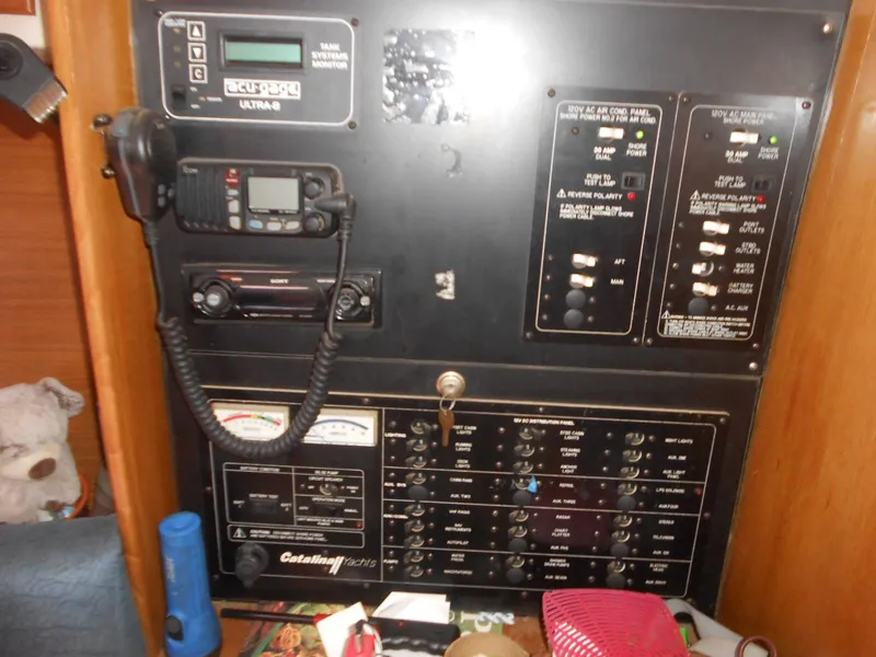 Slide: The Image of Electrical control panel of a 2004 Catalina 387 yacht with various switches and gauges. - 25